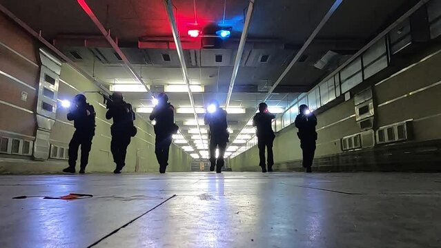 Training of a special forces group inside a building with automatic weapons.