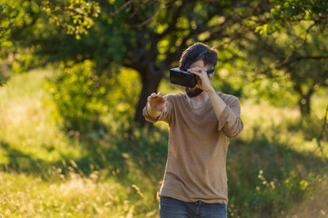 man wearing virtual reality glasses outdoors