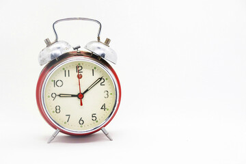 Old vintage alarm clock isolated on white background