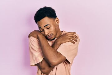 Young african american man wearing casual t shirt scared and amazed with open mouth for surprise, disbelief face