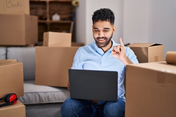 Young hispanic man having video call communicating with deaf language at new home