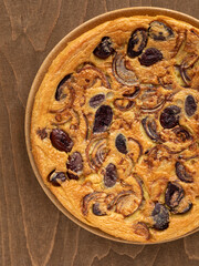 Farinata (Italian chickpea pancake) with kalamata olives and red onion.