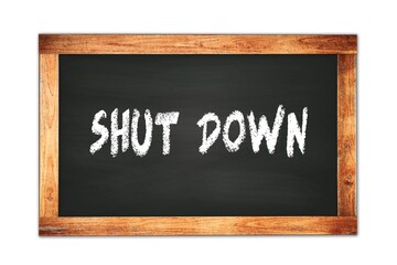 Fototapeta premium SHUT DOWN text written on wooden frame school blackboard.