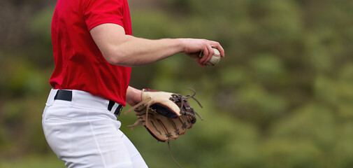 Baseball pitcher ready to pitch in baseball game, college softball player - obrazy, fototapety, plakaty