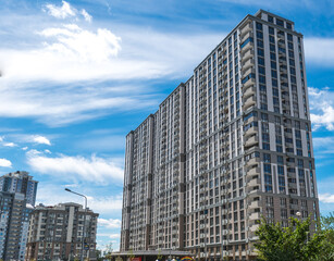 Fototapeta na wymiar Residential building in the center of Kiev, Ukraine. Multi-storey modern house on the background of a blue sky