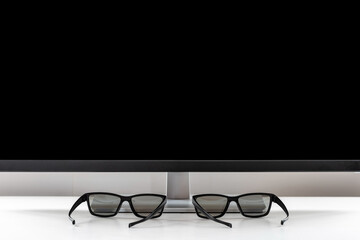 Classic glasses lie in front of the TV screen. Glasses for viewing a stereo image. Protective...