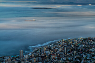 Aerial view of a cargo ship sailing goff Cape Town coastline during a foggy day, Cape Town, South Africa.