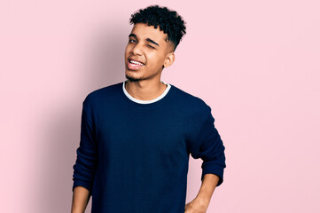 Young african american man wearing casual clothes winking looking at the camera with sexy...