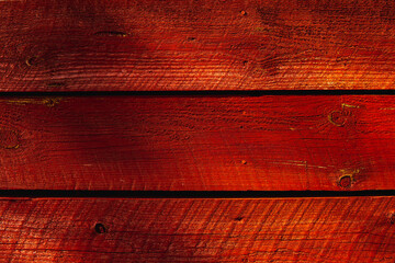 Red painted boards on a wall construction. Background countryside concept.