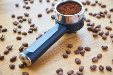 Coffee maker horn with Ground coffee on wooden background