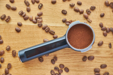 Coffee maker horn with Ground coffee on wooden background