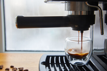 Making fresh coffee going out from a coffee espresso machine.