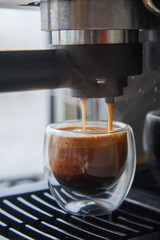 Making fresh coffee going out from a coffee espresso machine.