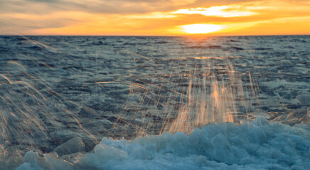 Scenic landscape of sunset above Baltic sea at winter. Long exposure.