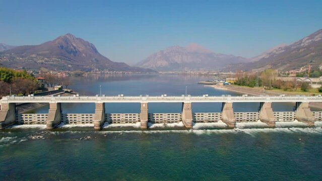 Water dam and lake aerial drone footage in Alps mountains generating hydro electricity power