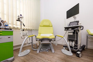 Empty gynecology office with modern colposcope and medical tools