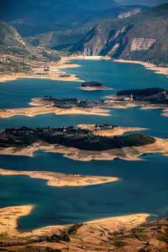 Aerial view of Rama Lake with a few buildings along the coast, Bosnia and Herzegovina.