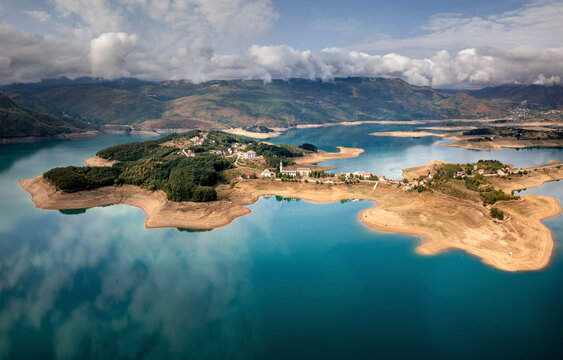 Aerial view of Rama Lake with a few buildings along the coast, Bosnia and Herzegovina.