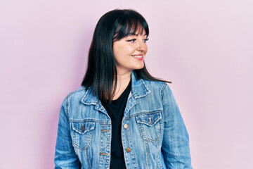Fototapeta premium Young hispanic woman wearing casual clothes looking to side, relax profile pose with natural face and confident smile.