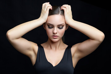 Fototapeta premium Beauty portrait of young woman. Brunette girl with evening female makeup and black dress