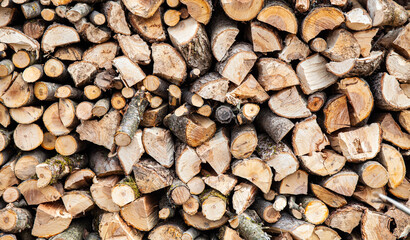 Background from a stack of firewood for a fireplace. Renewable energy source.