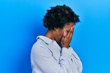 Young african american woman wearing casual clothes with sad expression covering face with hands while crying. depression concept.