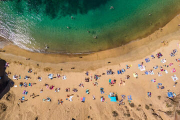 Aerial view of people on the beach at Playa del Papagayo (Papagayo Beach) near Playa Blanca, Lanzarote, Canary Islands, Spain.