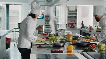 Female cook chopping bell peppers on cutting board to make professional cuisine dish. Woman chef cooking gourmet meal with organic food and vegetables, preparing recipe ingredients. - Powered by Adobe