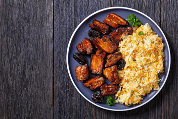 braised sauerkraut with pork and prunes on plate