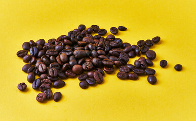  Bunch of coffee beans over yellow background