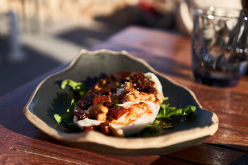  Plate of burrata salad on wooden surface