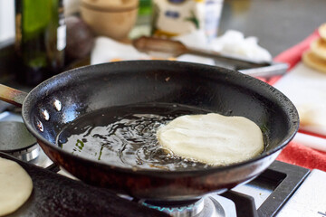 frying arepas in a pan
