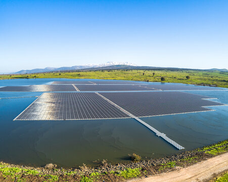 Aerial view of a water reservoir covered with floating solar panels, Orvim Reservoir, Golan Heights, Israel.