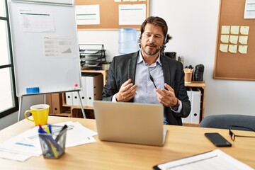 Middle age caucasian man call center agent having video call at office