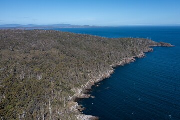 Fototapeta na wymiar tasmanian coastal landscape in australia. aerial photos of rocky ocean views in southern tasmania. showing towns and farms.
