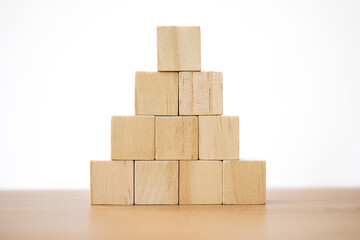 wooden cube block toy stacked in pyramid shape without graphics for Business design concept and...