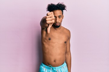 Fototapeta premium Young african american man with beard wearing swimsuit looking unhappy and angry showing rejection and negative with thumbs down gesture. bad expression.