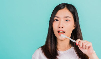 Asian beautiful young woman teen brushing teeth in the morning, portrait of happy Thai female...