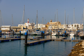 Obraz premium View of the town of Rota from the marina with boats and the lighthouse, Cadiz, Spain