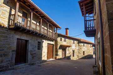 Fototapeta na wymiar Street of the town of Villardeciervos with old stone buildings and wooden balconies. Zamora. Spain 