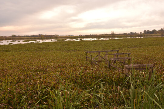 Old wooden construction in a field on a gloomy day