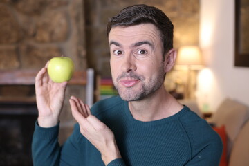 Healthy slim man holding apple