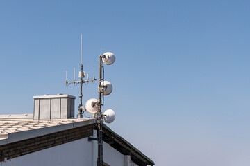 Telecommunication antennas on the roof of an industrial building.