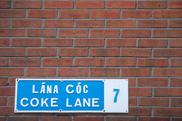 Sign Coke lane 7 in Irish and English language on a street in Dublin city, Ireland. Copy space....