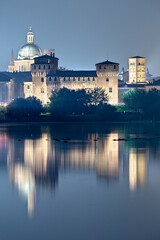 Fototapeta na wymiar Mantova: the San Giorgio castle is reflected on the middle lake of the Mincio river. The city has been included in the list of UNESCO World Heritage Sites. Lombardy, Italy, Europe.