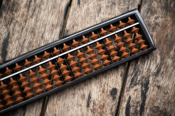 Close up abacus on wood table.