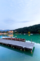 Naklejka premium Lake Lavarone with rowing boats moored at the pier. Cimbra Alp, Trentino, Italy.