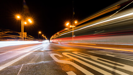 Long exposure shot of car lights on a highway at night © Andy-27/Wirestock Creators