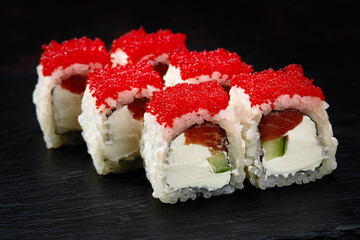 Sushi. Philadelphia roll with fresh salmon, cucumber, avocado, cream cheese, tobiko red caviar
