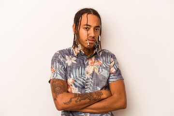 Young African American man isolated on white background frowning face in displeasure, keeps arms...
